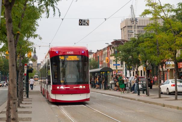 A TTC streetcar driving down a street in Toronto