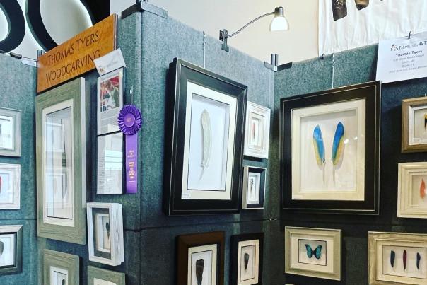 Printed and framed artwork on display at the Festival of the Arts event