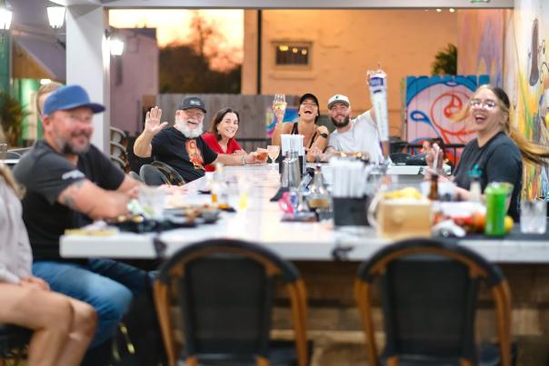 A group of friends sitting at an open-air bar.