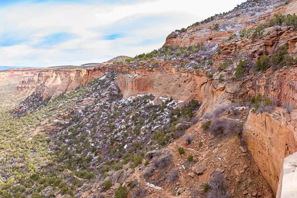 Woman stands at overlook in Colorado National Monument in the Winter