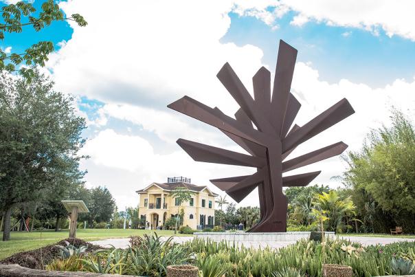 "Steel Palm" sculpture and Central Building at Peace River Botanical & Sculpture Gardens in Punta Gorda