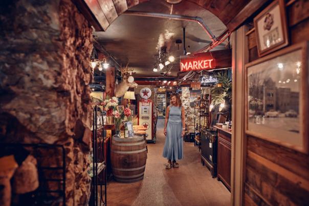 Person walking in an antique store.