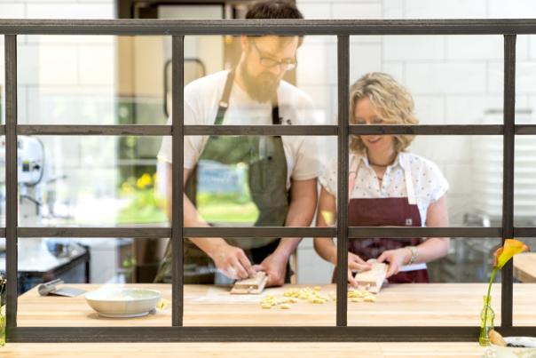 looking at Zak & Sarah Baker making pasta through a window