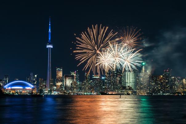Fireworks explode off the CN Tower at night