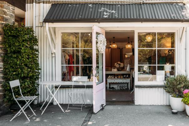 Outside view of a a white, cottage-style looking boutique shop