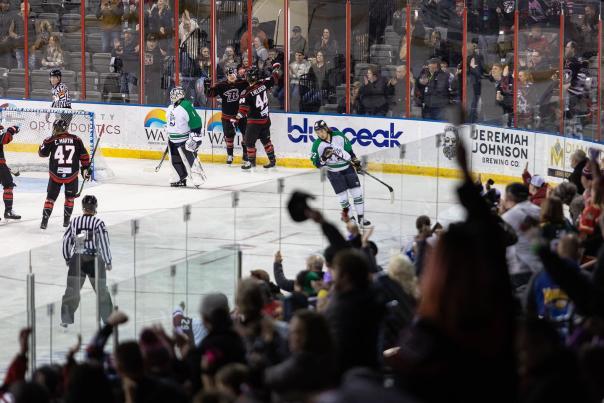 audience cheering on the rapid city rush hockey team during a game in rapid city, sd
