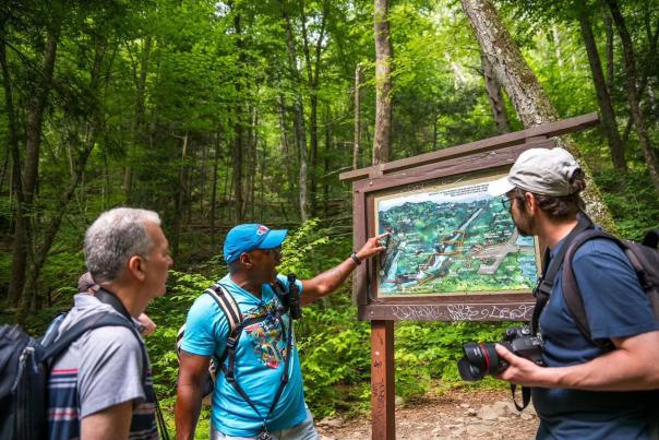 A group consults a map of hiking trails in the Poconos.
