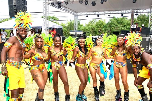 Karnival Bounce Dancers line up in costume and smile for a photo