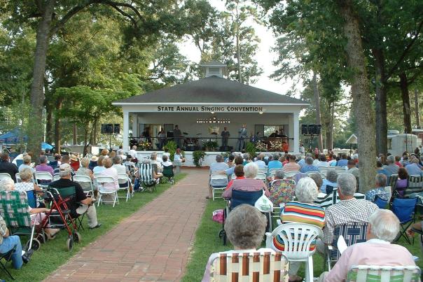 A large crowd gathered at the Benson Singing Grove to watch a performer in Benson, NC.
