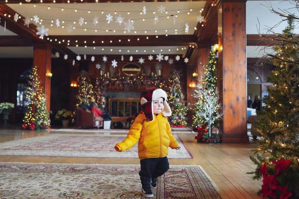 A little child explores the Christmas decorations at Skytop Lodge in the Poconos.