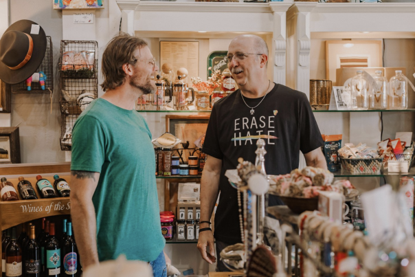 Two men speaking in a shop