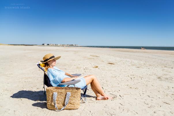 a woman sitting in a beach chair