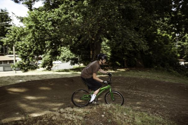 A person on a mountain bike riding down a dirt trail.