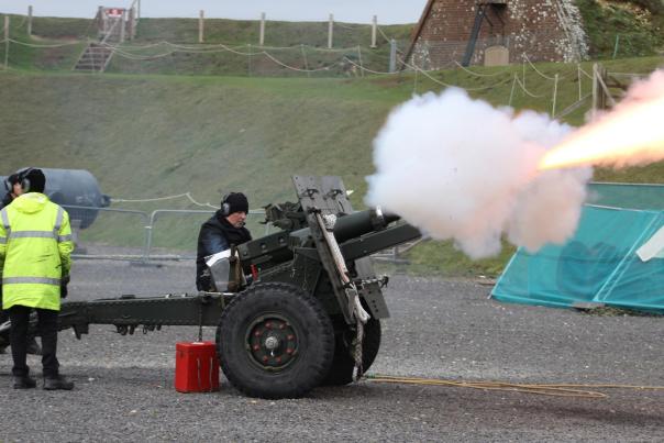 Photograph showing the moment a big gun is fired at a display at Fort Nelson, with a historic weapon producing lots of smoke and fire