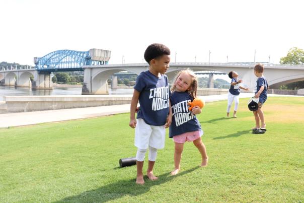 Kids play in Coolidge Park wearing Chattanooga shirts