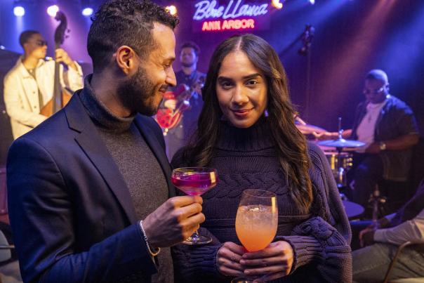 Couple holding drinks at Blue Llama Jazz Club