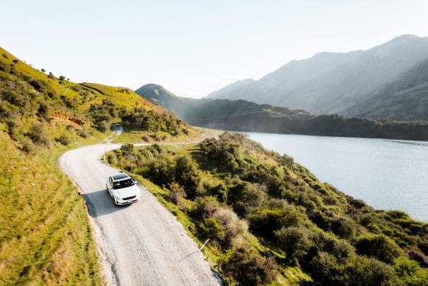 EV driving to Moke Lake with mountains in the background