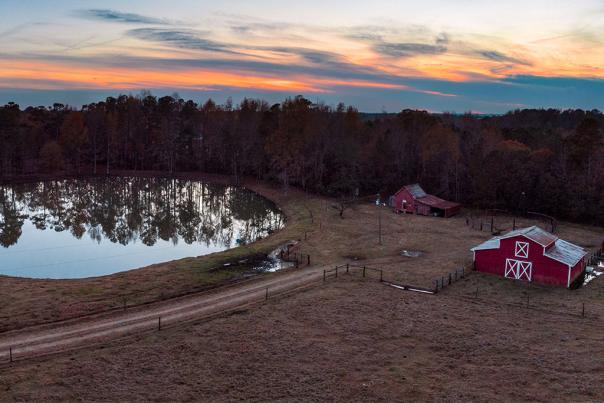 Rural photo of red barn and pond in Clayton, NC.