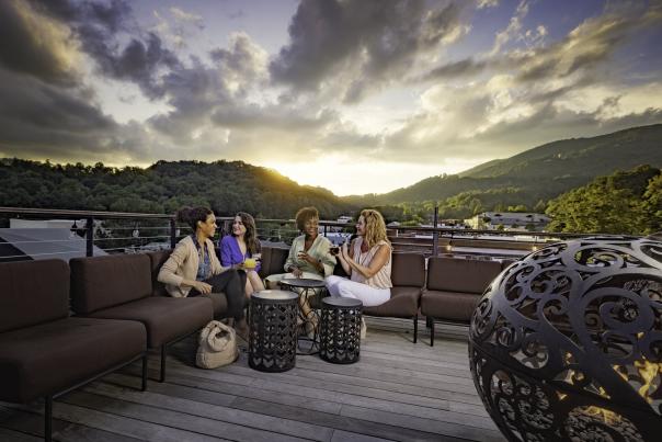 A group of women chat while waiting for sunset on the rooftop at the Horton Hotel.