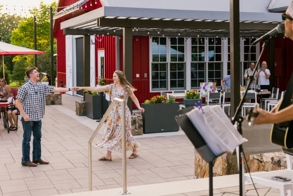 A man and woman dance to live music on the patio at Aubrey Vineyards.
