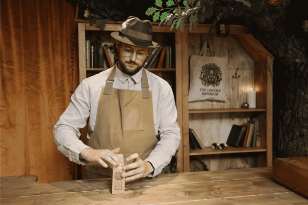 a shop worker is packaging a product