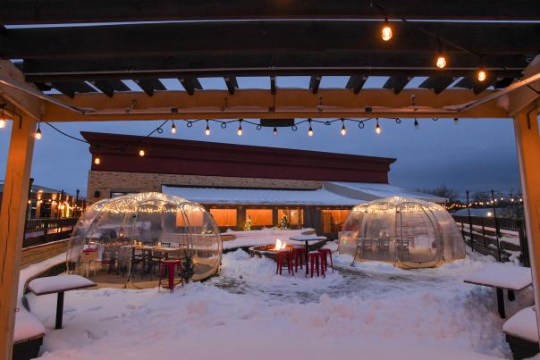 Two domes covered in snow on the patio outside of Lone Girl Brewing Company