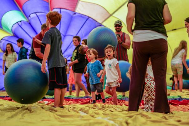 Children playing inside a hot air balloon at Jamesville Balloonfest