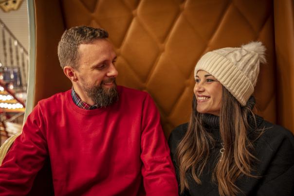 Couple sitting on Carousel in Winterwear