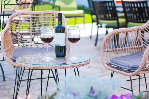 Union Cellars Winery Spring Patio with wine glasses filled next to an open bottle of refreshing wine