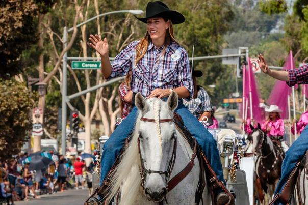 Two women riding horses in the rodeo parade in Norco, CA