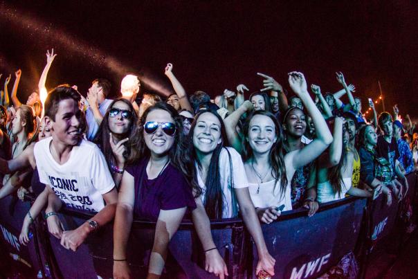A group of people at the front row of a music performance