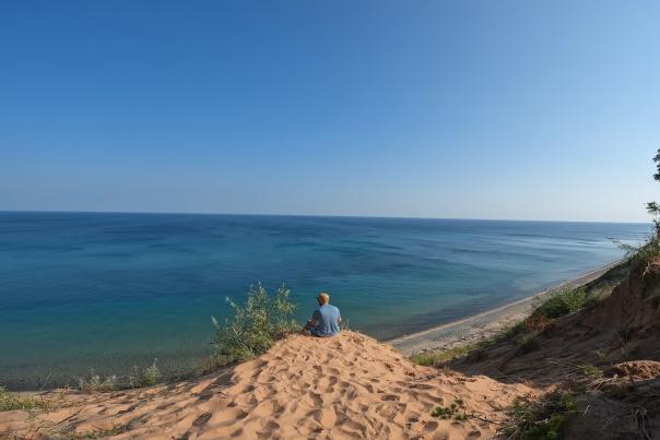 A man looking out out at Lake Superior at Pictured Rocks National Lakeshore in the Upper Peninsula of Michigan