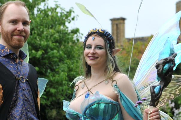 A man and woman in front of Sudeley Castle dressed in fairy costumes