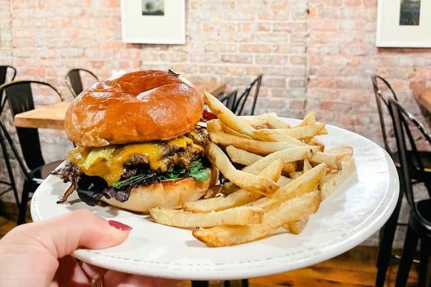A plate featuring a hearty burger and fries from Delft Bistro in Marquette, MI