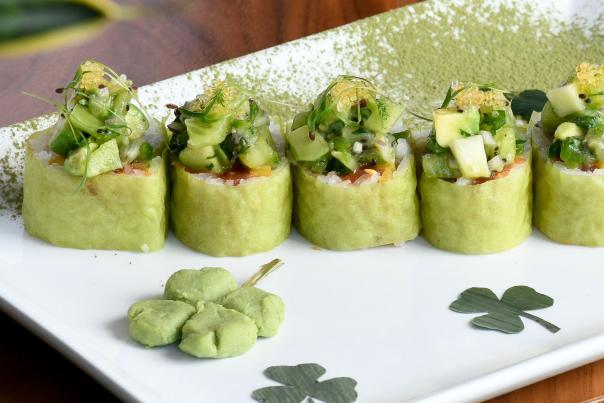 Green sushi rolls in a line on a plate decorated with shamrocks from RED