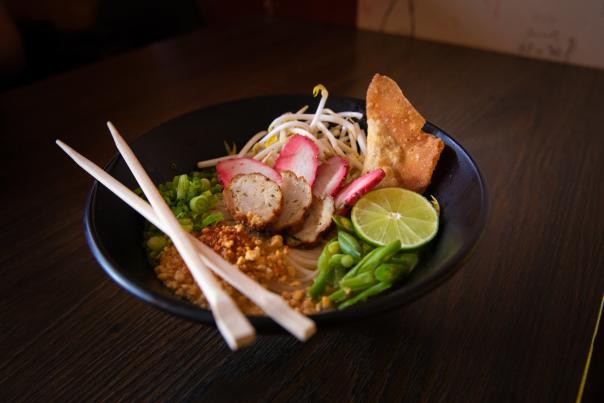 bowl of ramen with chopsticks crossed on top