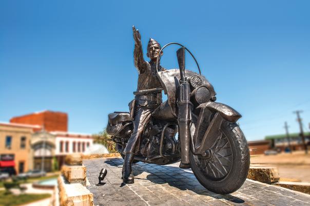 A statue of General Darby on a motorcycle sits in Cisterna Park in Fort Smith