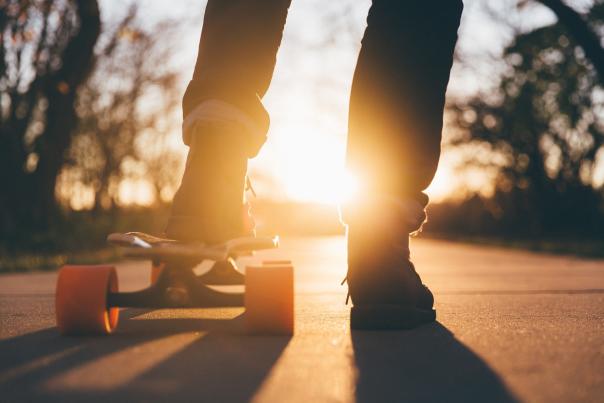 a picture of a person's legs and a skateboard
