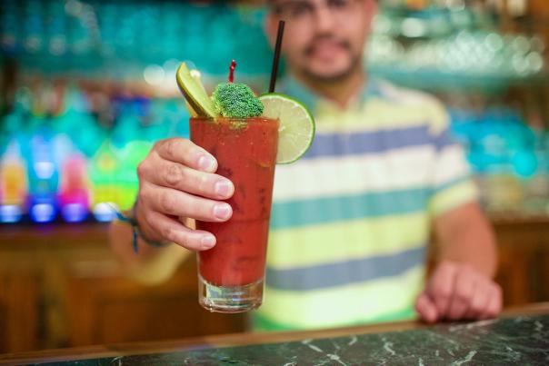 Bloody Mary being held up by an Apartment Lounge bartender