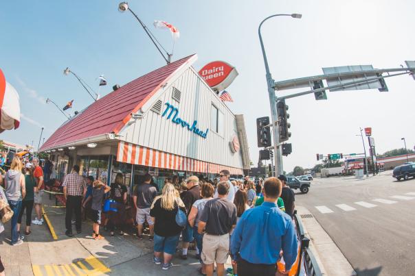 line of people on sidewalk in front of moorhead dairy queen