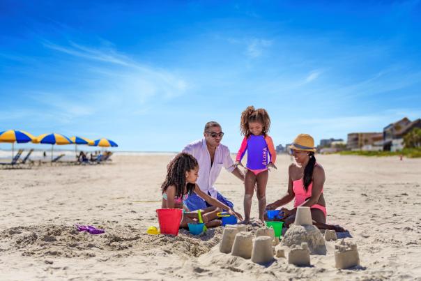 Family on beach making a sandcastle