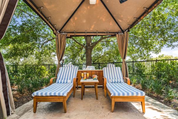 Two lounge chairs under a covered area