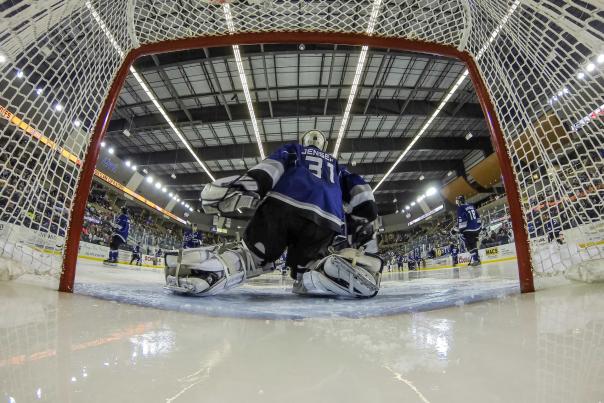 hockey goalie in front of net during game