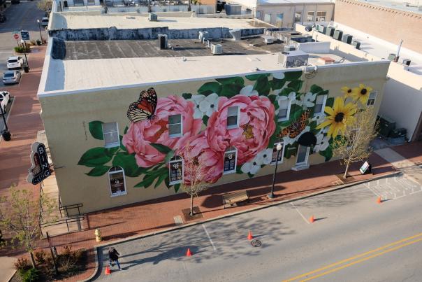 Louise “Ouizi” Jones, Summer Always Blooms, 2021, Acrylic paint. Located at W Central Ave and N Main Street. Collection of Oz Art NWA