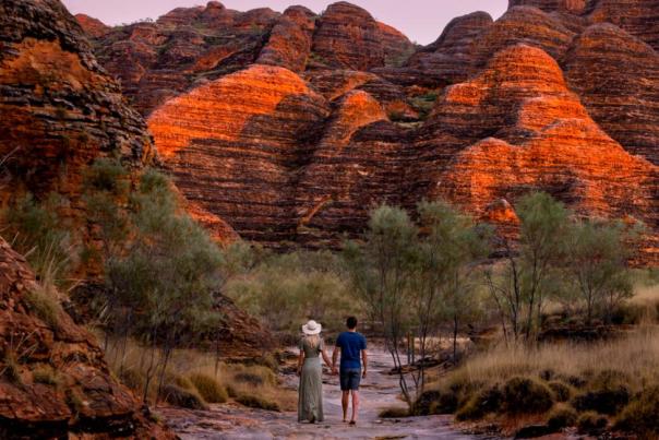 Two people walking up to the Bungles in Purnululu National Park destination hero image