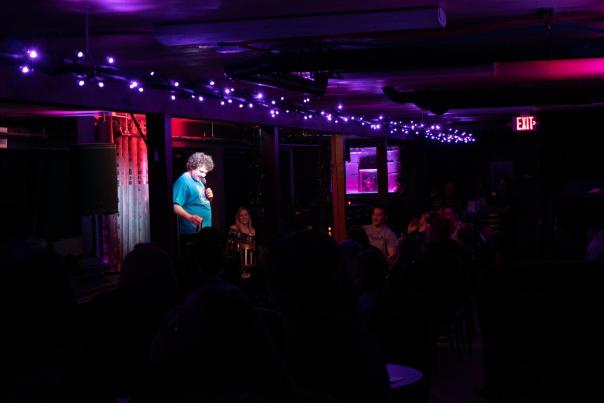 comedian on stage for open mic comedy night at the cellar