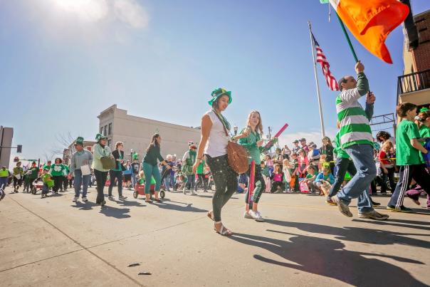 people walking in a St. Patricks day parade in downtown Fargo