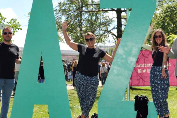 Four big letters stating JAZZ to celebrate Cheltenham Jazz Festival with people standing in between them