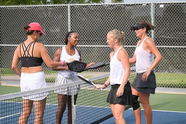 Players touch paddles after a game at the 2024 Madtown Pickleball Open, Wisconsin's largest outdoor pickleball tournament