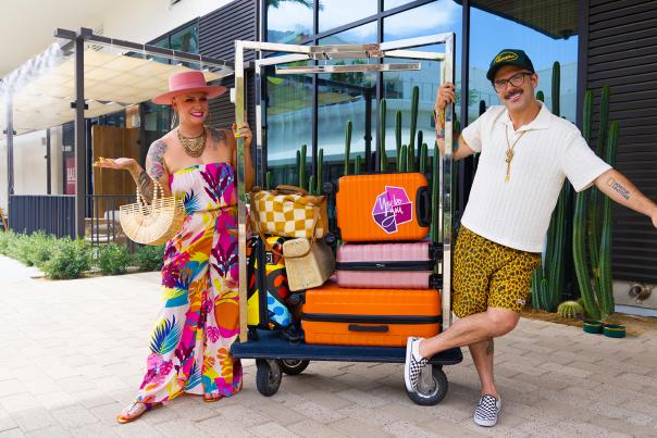 Two people out front at the Thompson Palm Springs hotel with luggage